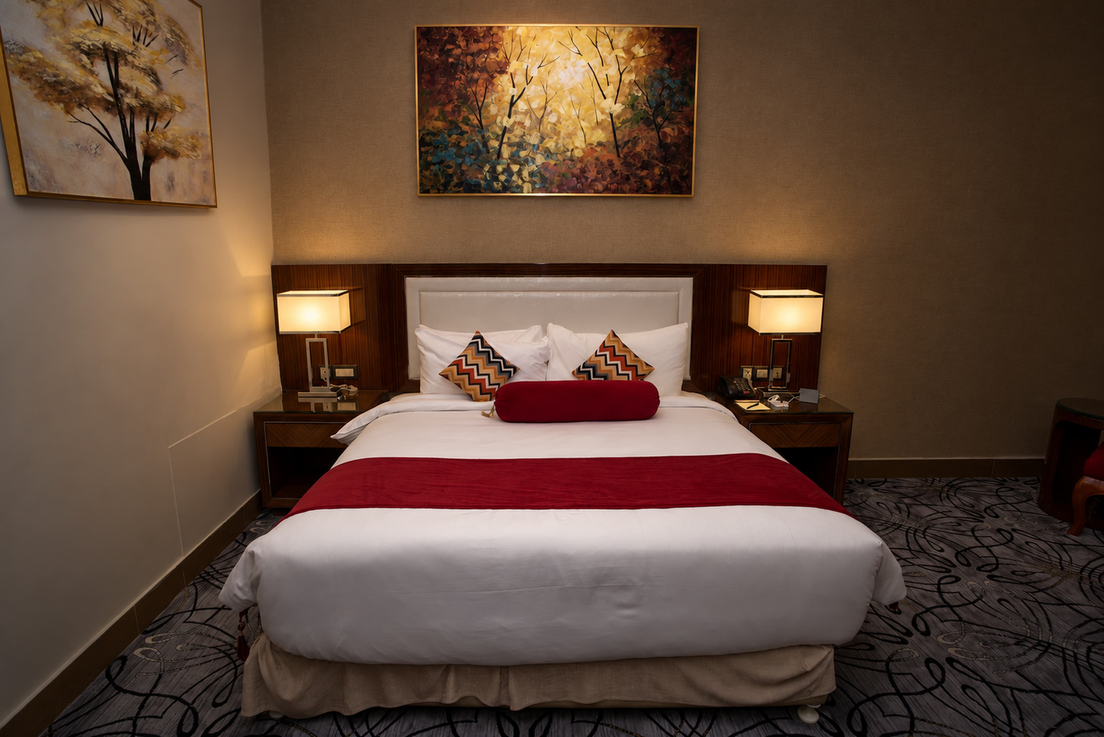 A Comfort Room at Royal Swiss Lahore, with a red bolster and runner